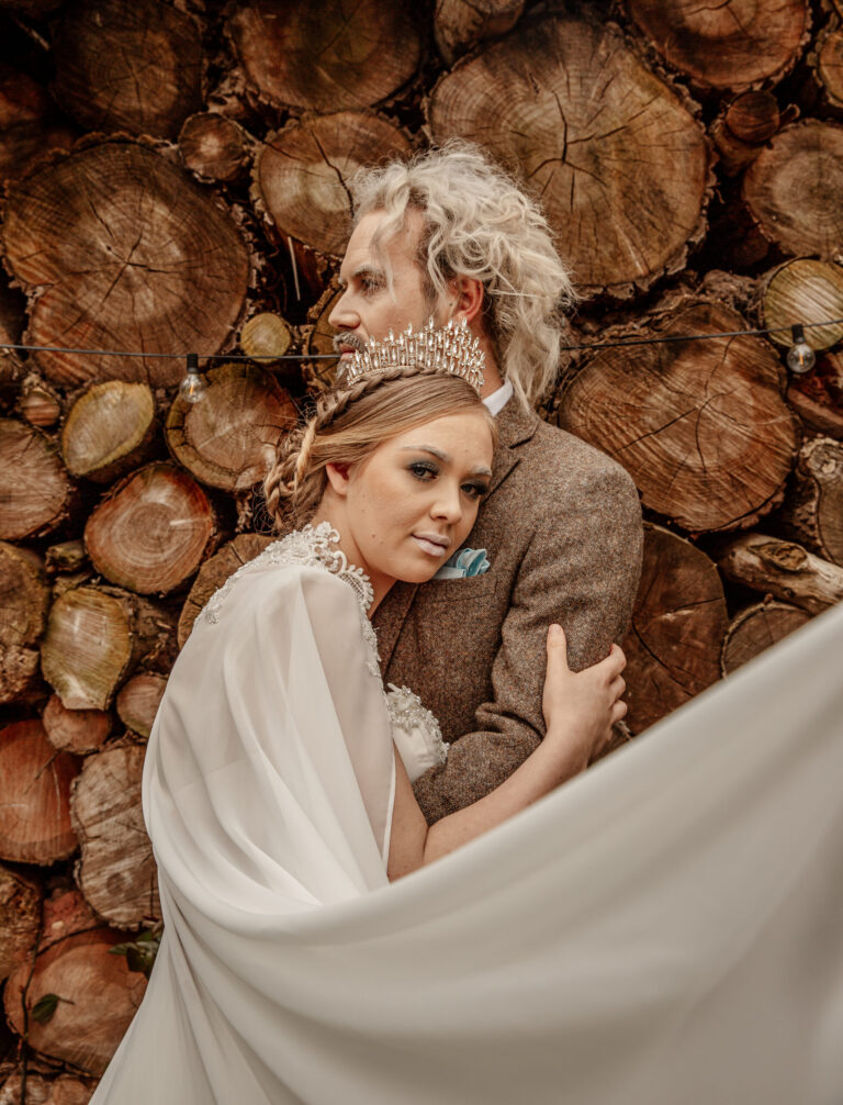Bride And Groom Hug Winter Wedding Log Wall Veil